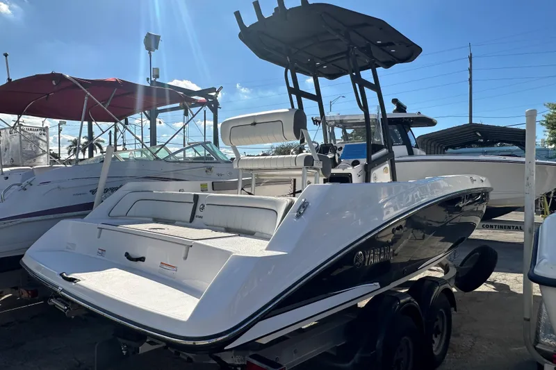 Slide: The Image of 2020 Yamaha Boats 210 FSH in a marina, showcasing sleek design and modern features. - 14
