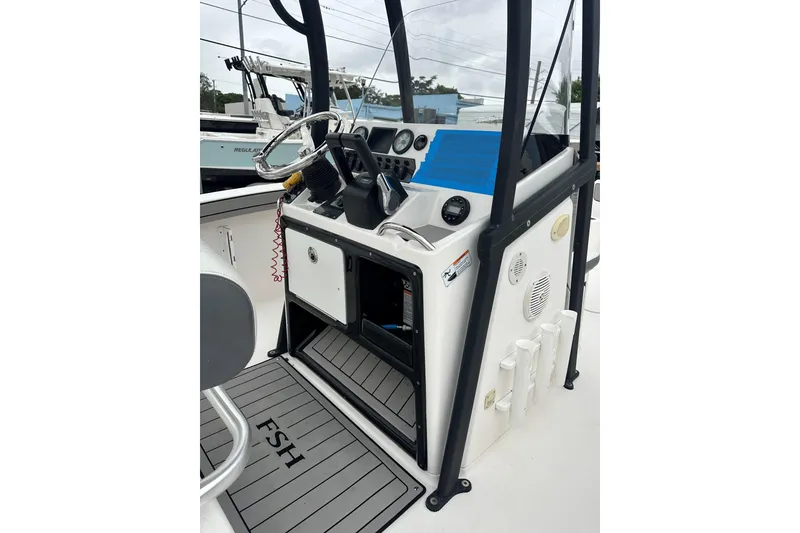 Slide: The Image of 2020 Yamaha Boats 210 FSH console with steering wheel and controls. - 7