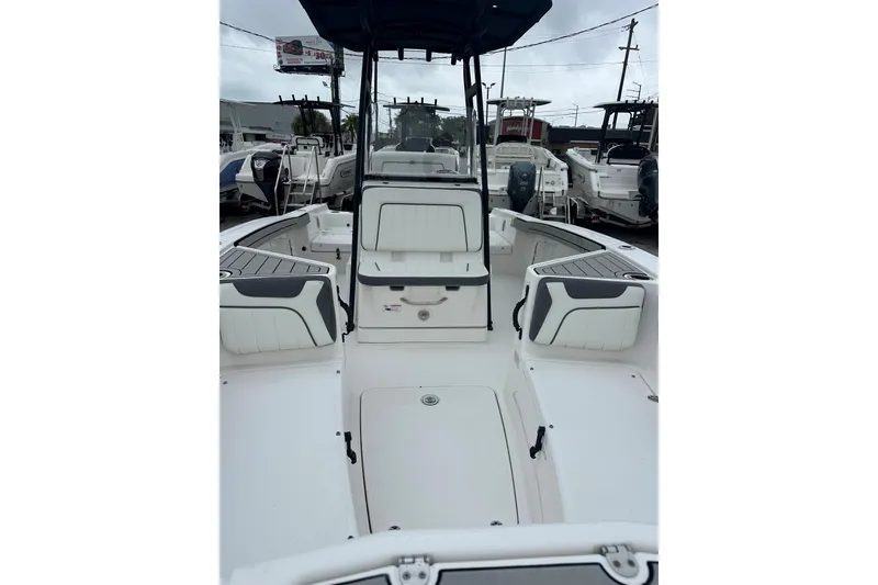 Slide: The Image of 2020 Yamaha Boats 210 FSH interior view, showcasing seating and helm area. - 8