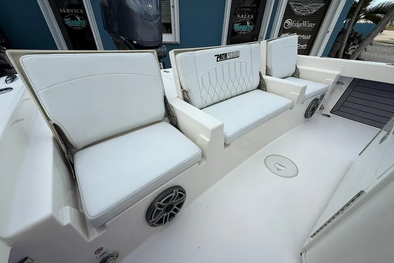 Slide: The Image of 2023 Pathfinder 2600 TRS boat interior with white cushioned seating and speakers. - 11