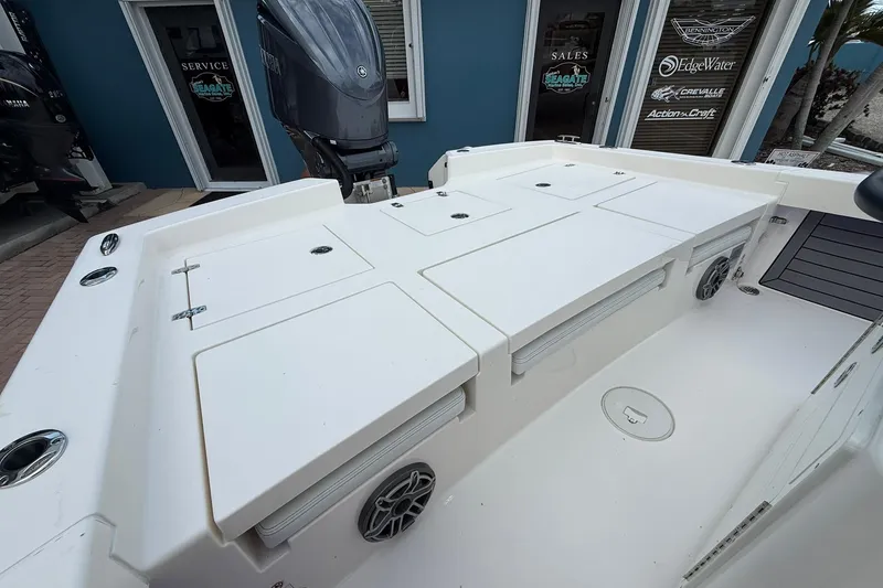 Slide: The Image of 2023 Pathfinder 2600 TRS boat deck with storage compartments and motor, displayed at a dealership. - 15