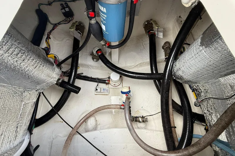 Slide: The Image of 2023 Pathfinder 2600 TRS boat interior showing wiring and plumbing components. - 19