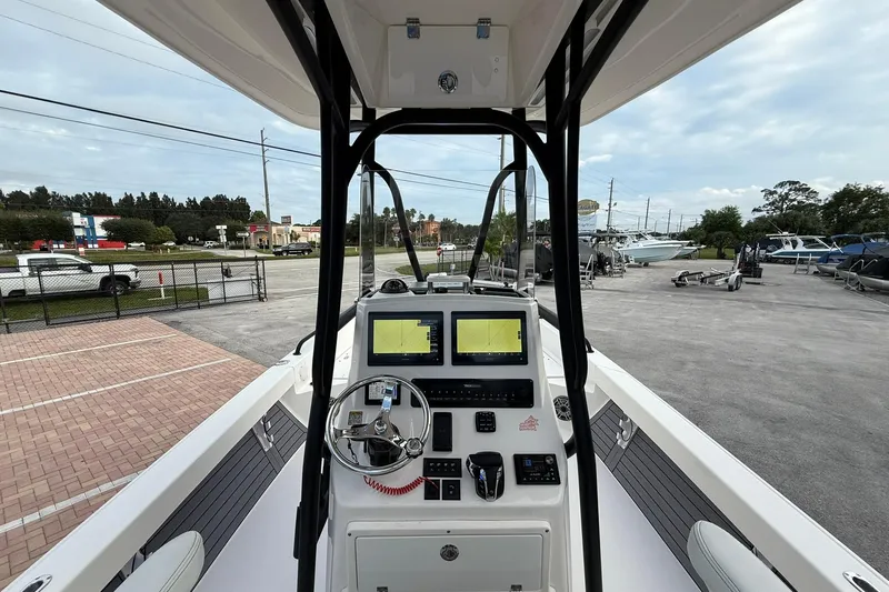 Slide: The Image of 2023 Pathfinder 2600 TRS boat console with dual screens and steering wheel. - 20