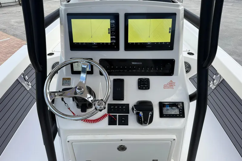 Slide: The Image of 2023 Pathfinder 2600 TRS boat console with dual Garmin displays and steering wheel. - 21