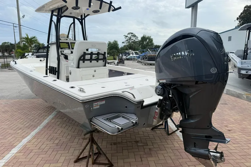 Slide: The Image of 2023 Pathfinder 2600 TRS boat with Yamaha outboard engine, parked on brick pavement. - 3