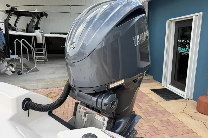 Slide: The Image of 2023 Pathfinder 2600 TRS with Yamaha outboard motor in a service area. - 8