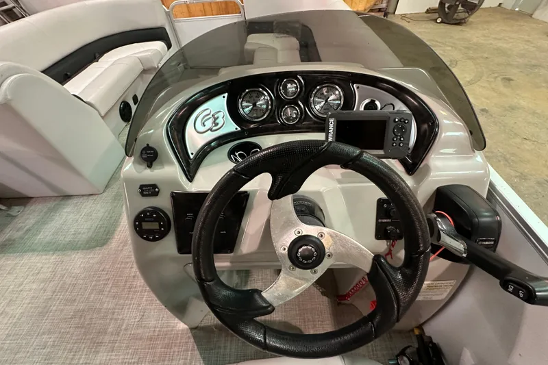 Slide: The Image of 2019 SunCatcher V22 Cruise boat dashboard with steering wheel and control panel. - 11