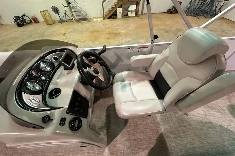 Slide: The Image of Captain's seat and dashboard of 2019 SunCatcher V22 Cruise boat, featuring modern controls. - 12