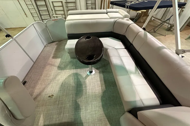Slide: The Image of Interior of 2019 SunCatcher V22 Cruise pontoon boat with plush seating and central table. - 14