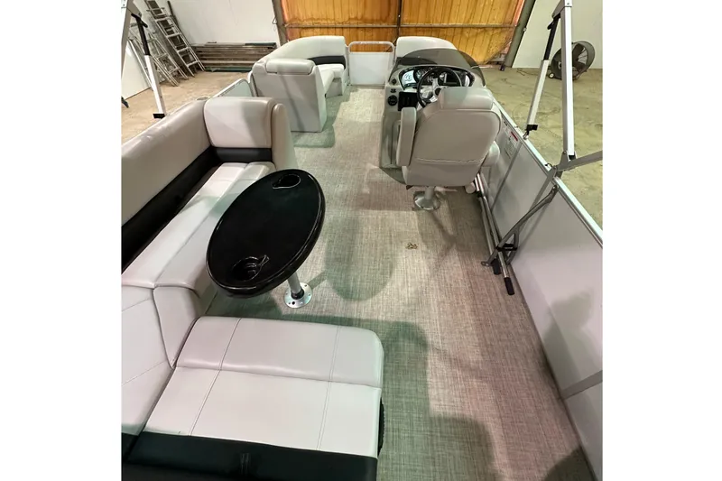Slide: The Image of 2019 SunCatcher V22 Cruise pontoon boat interior with seating and steering console. - 18