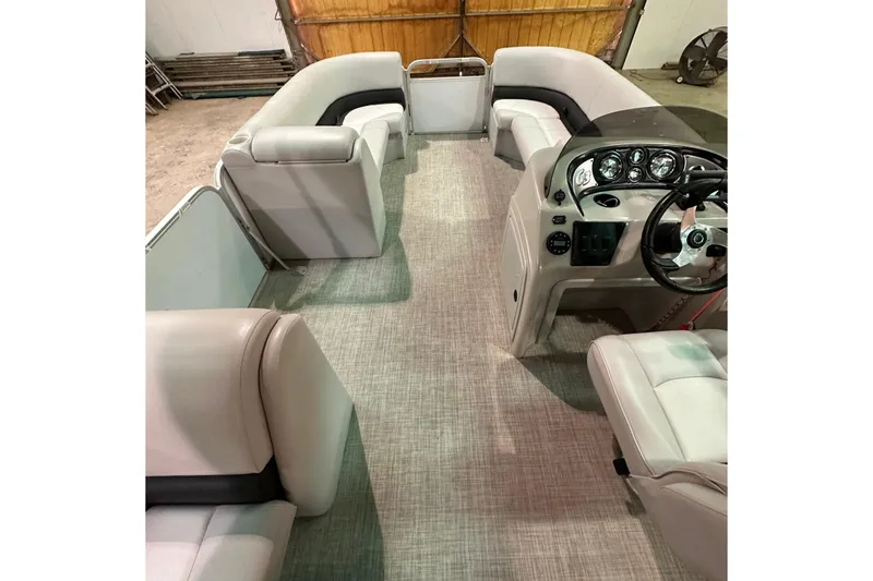 Slide: The Image of Interior of 2019 SunCatcher V22 Cruise pontoon boat with plush seating and control console. - 19