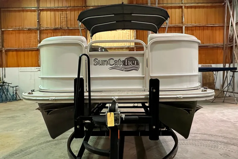 Slide: The Image of 2019 SunCatcher V22 Cruise pontoon boat in a warehouse setting. - 2