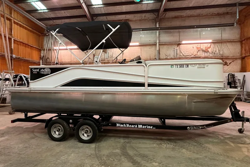 Slide: The Image of 2019 SunCatcher V22 Cruise pontoon boat on trailer in indoor storage facility. - 3
