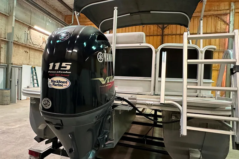 Slide: The Image of 2019 SunCatcher V22 Cruise boat with Yamaha 115 outboard motor in a warehouse. - 5