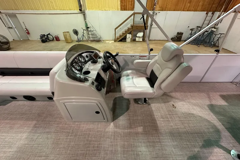Slide: The Image of 2019 SunCatcher V22 Cruise boat interior with captain's chair and control panel. - 8