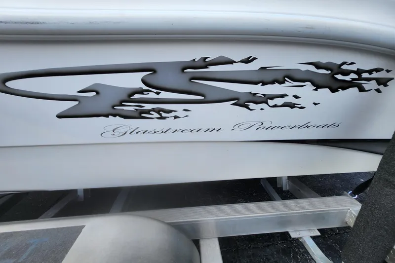 Slide: The Image of 2020 Glasstream 240 CCX boat logo on hull, featuring sleek design and branding. - 12