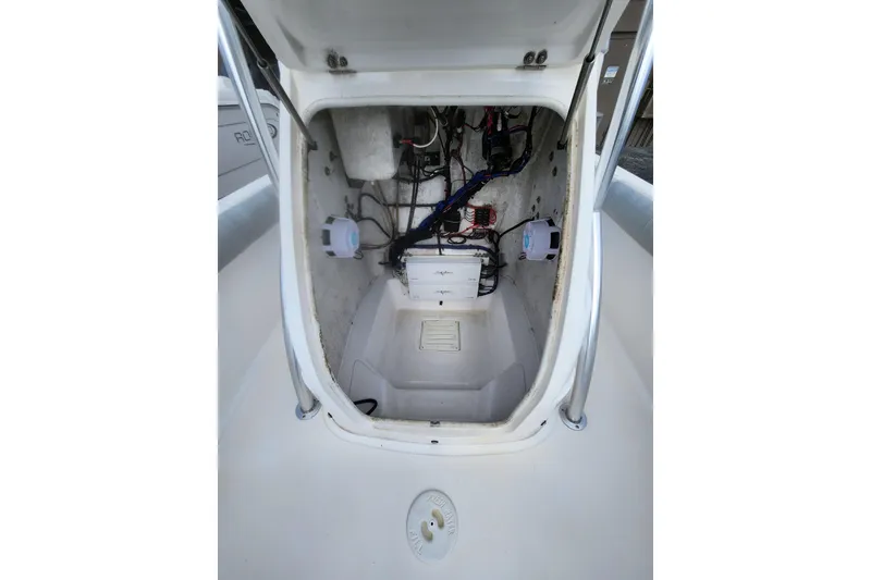 Slide: The Image of 2020 Glasstream 240 CCX boat interior wiring and storage compartment. - 13