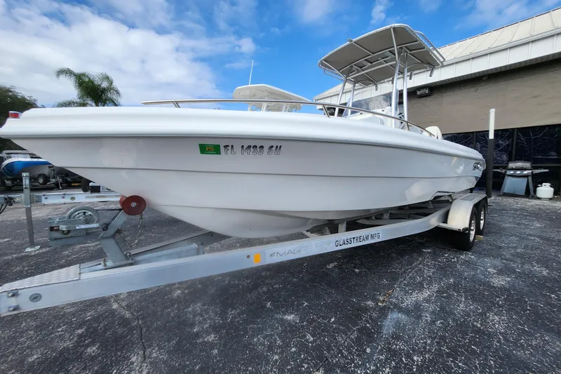 Slide: The Image of 2020 Glasstream 240 CCX boat on trailer, parked outdoors under a blue sky. - 16