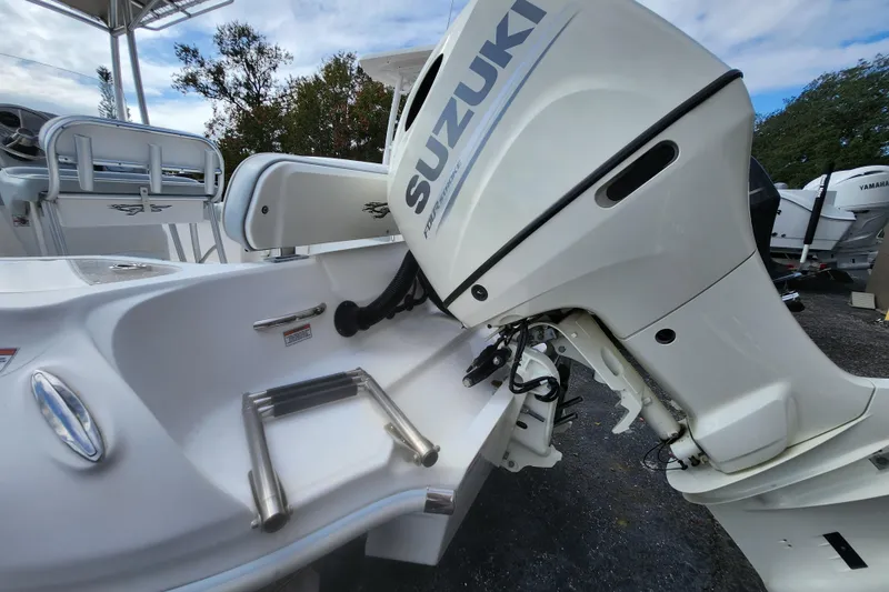 Slide: The Image of 2020 Glasstream 240 CCX boat with Suzuki outboard motor, featuring a sleek white design. - 2