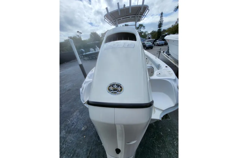 Slide: The Image of 2020 Glasstream 240 CCX boat, rear view, parked outdoors under cloudy sky. - 4