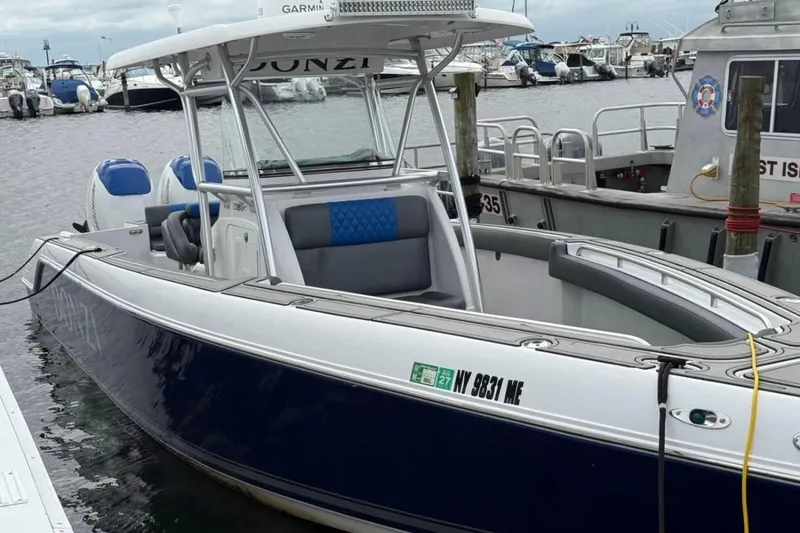 Slide: The Image of 2008 Donzi 32 ZF boat docked in marina, featuring sleek design and dual engines. - 3