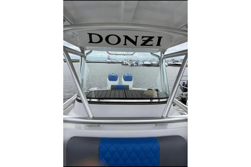 Slide: The Image of 2008 Donzi 32 ZF boat interior with blue seating, docked at marina. - 4