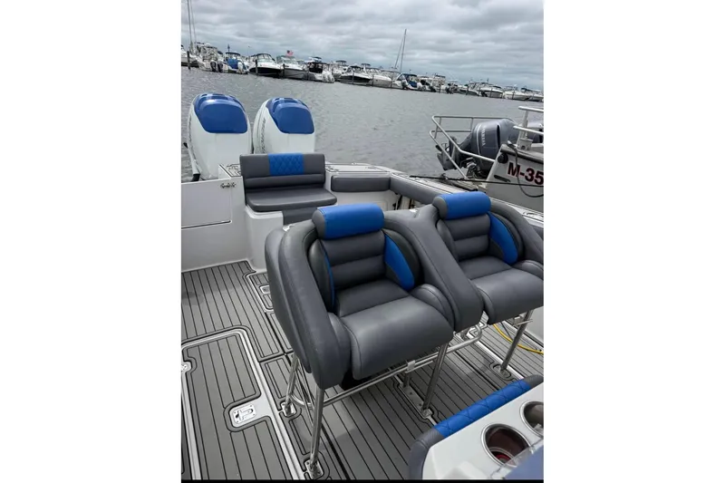 Slide: The Image of 2008 Donzi 32 ZF boat interior with blue and gray seating, docked at marina. - 5