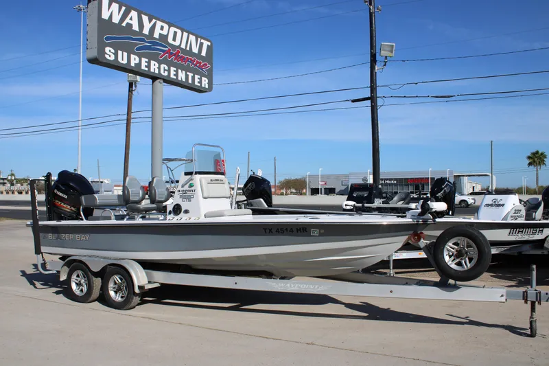 Slide: The Image of Open storage compartment on 2020 Blazer 2220 GTS boat, featuring speakers and trolling motor. - 14