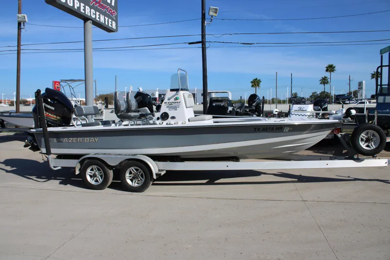 Slide: The Image of 2020 Blazer 2220 GTS boat on trailer, parked outdoors under clear blue sky. - 17
