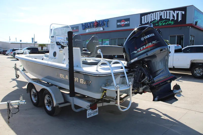 Slide: The Image of 2020 Blazer 2220 GTS boat interior with seating and control panel, displayed outdoors. - 20