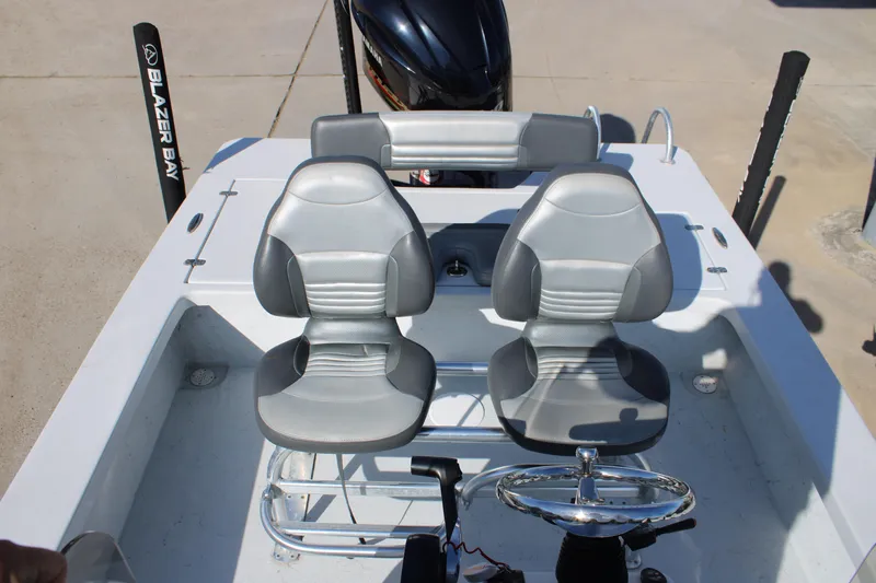 Slide: The Image of 2020 Blazer 2220 GTS boat with seating and console, parked on concrete. - 6