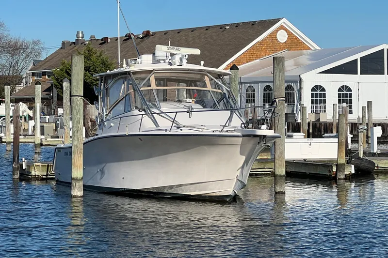 The Image of 2006 Grady-White Express 330 boat docked at marina with clear blue sky. - 0