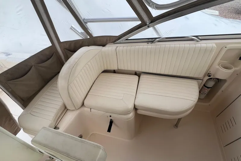 Slide: The Image of 2006 Grady-White Express 330 boat interior with white cushioned seating. - 10