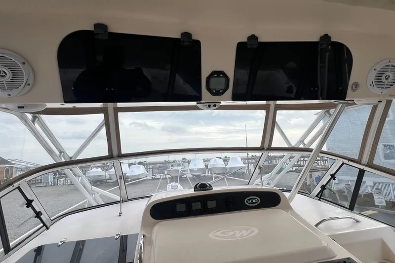 Slide: The Image of 2006 Grady-White Express 330 boat interior with dashboard and marina view. - 12
