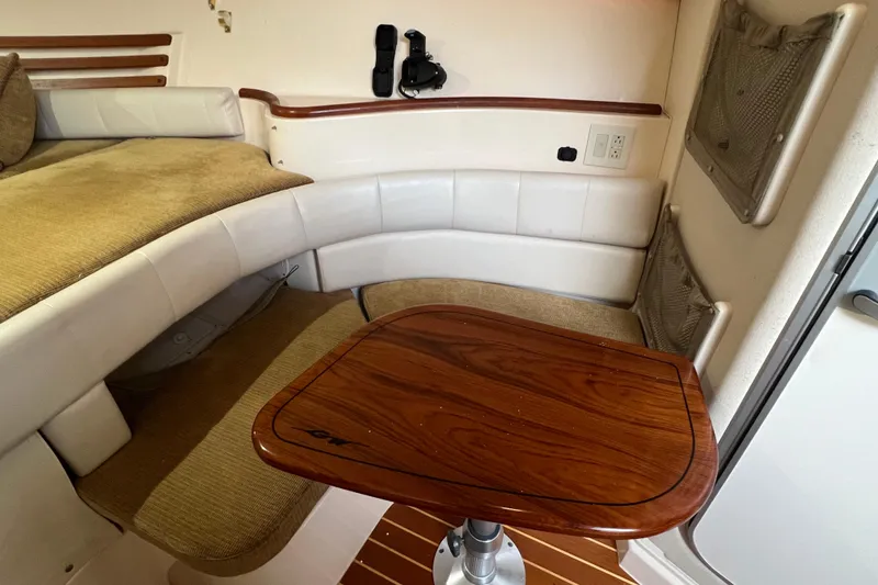 Slide: The Image of Interior of 2006 Grady-White Express 330 boat with seating and wooden table. - 15
