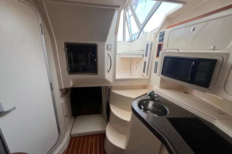 Slide: The Image of 2006 Grady-White Express 330 interior with kitchenette, microwave, and control panel. - 19
