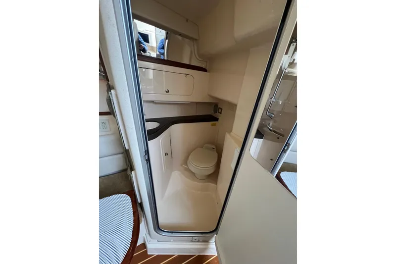 Slide: The Image of 2006 Grady-White Express 330 boat bathroom interior with compact design and modern amenities. - 20