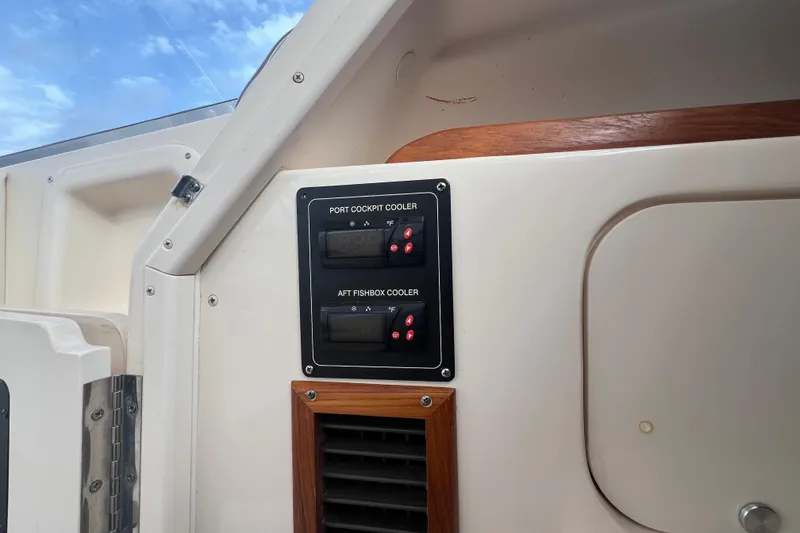 Slide: The Image of Control panel on a 2006 Grady-White Express 330 boat, featuring cockpit and fishbox coolers. - 24
