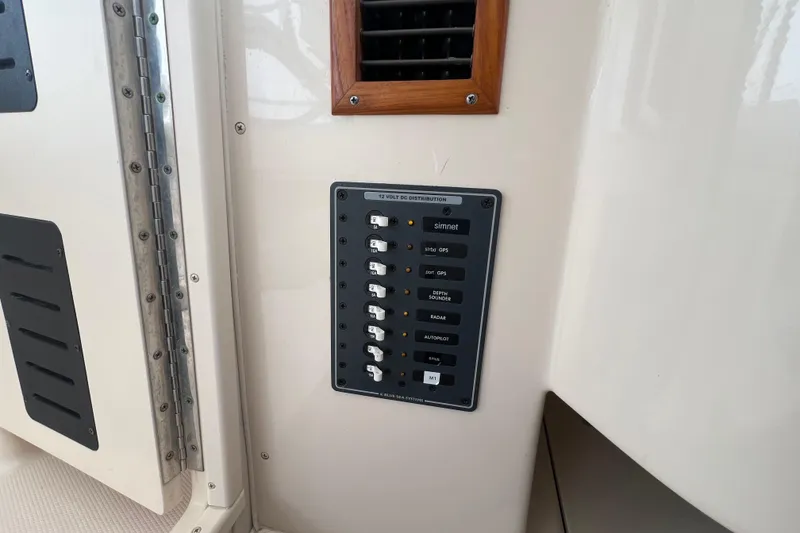 Slide: The Image of Control panel on 2006 Grady-White Express 330 boat, featuring various switches and labels. - 25