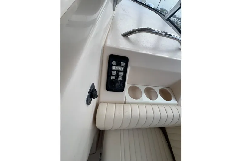 Slide: The Image of 2006 Grady-White Express 330 boat interior with FLIR control panel and cup holders. - 26