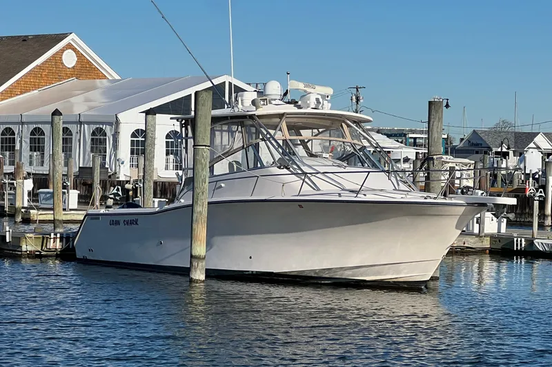 Slide: The Image of 2006 Grady-White Express 330 boat docked at marina, clear blue sky. - 5