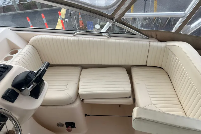 Slide: The Image of 2006 Grady-White Express 330 boat interior with cream seating and control panel. - 9