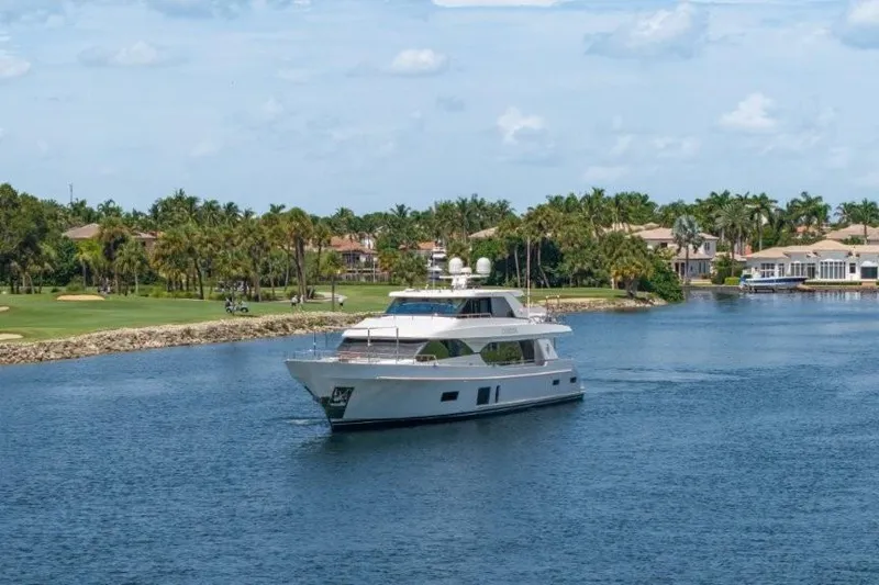 Slide: The Image of 2017 Ocean Alexander Motor Yacht cruising on a scenic waterway with palm trees. - 25