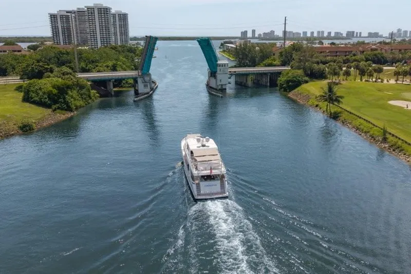 Slide: The Image of 2017 Ocean Alexander Motor Yacht passing under a raised drawbridge on a scenic waterway. - 27