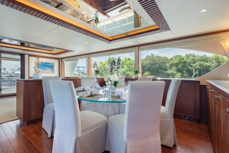 Slide: The Image of Luxurious dining area inside a 2017 Ocean Alexander Motor Yacht, featuring elegant decor and large windows. - 30