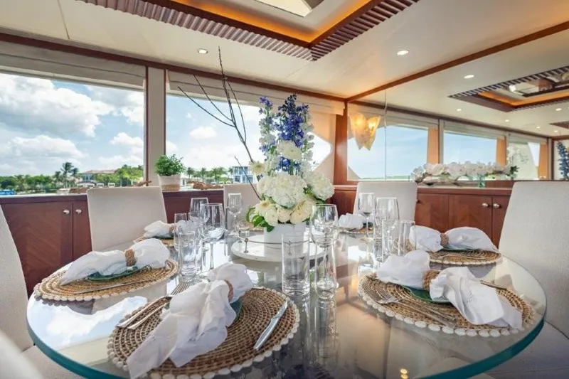Slide: The Image of Luxurious dining area on a 2017 Ocean Alexander motor yacht, featuring elegant table settings. - 32