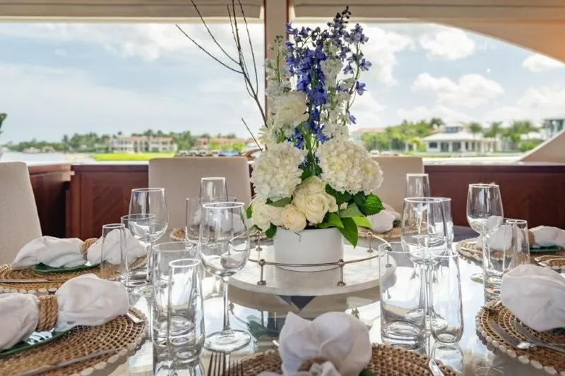 Slide: The Image of Elegant dining setup on 2017 Ocean Alexander Motor Yacht with floral centerpiece. - 33