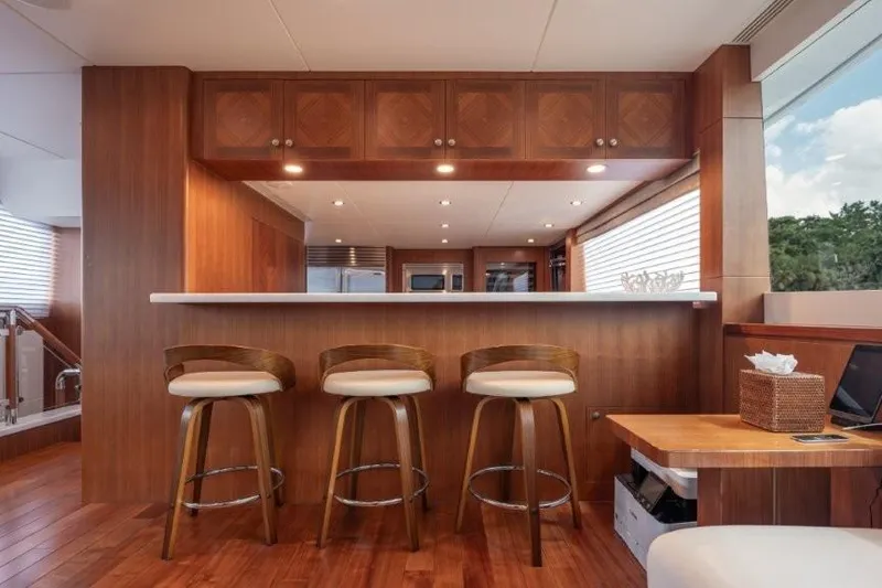 Slide: The Image of Luxurious 2017 Ocean Alexander motor yacht interior with elegant wooden bar and seating. - 42