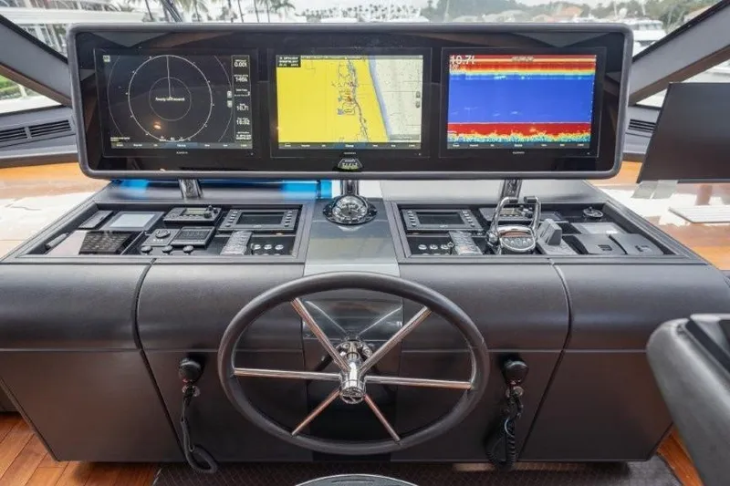 Slide: The Image of Control panel of a 2017 Ocean Alexander Motor Yacht with navigation screens and steering wheel. - 44