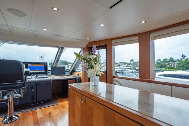 Slide: The Image of Luxurious 2017 Ocean Alexander motor yacht interior with elegant wood finishes and floral arrangement. - 46